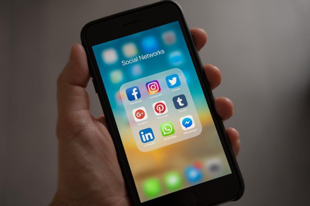 Various social media logos displayed on a smartphone monitor