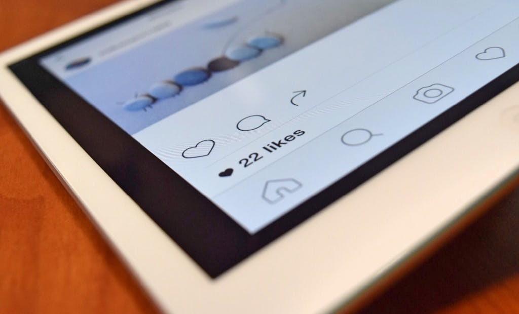 iPad screen showing an Instagram page with 22 likes
