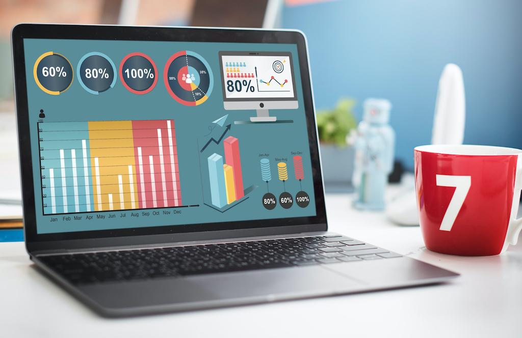 A display of percentage graphics on a laptop monitor to illustrate digital marketing cost for small businesses